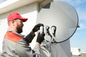 service worker installing and fitting satellite antenna dish for cable TV