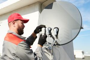 service worker installing and fitting satellite antenna dish for cable TV