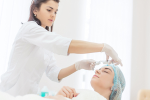 beautician puts protective glasses on a client