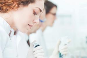 scientists pipetting sample in a lab