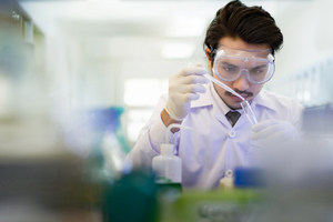 Asian scientist in the laboratory working with test tubes